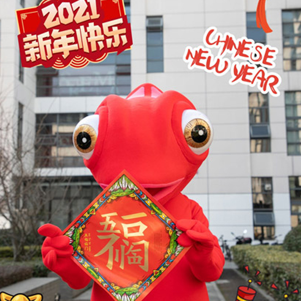 SKEMA's live mascot, a tall orange Leon the chameleon, stands on the school's China campus while holding a red card sent to students in celebration of the Chinese Lunar New Year.