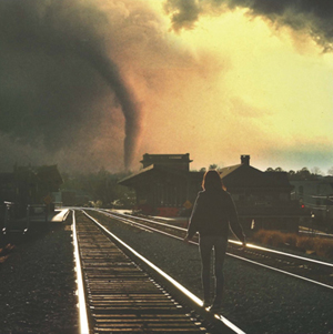 Photo titled This Is Where the Rich Kids Come to Die by Nicholas Max of a young woman standing on a railroad tracks looking at a tornado in the distance as hazy light comes through the clouds at right