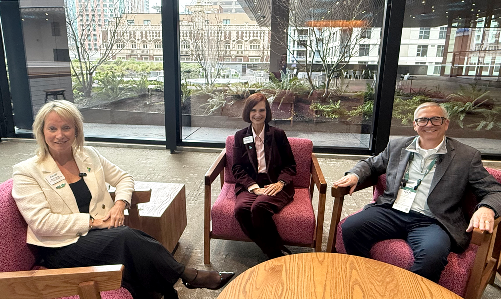 Eileen McAuliffe, Stephanie Bryant, and Frank Buckless sitting in arm chairs around a table at the Seattle Convention Center