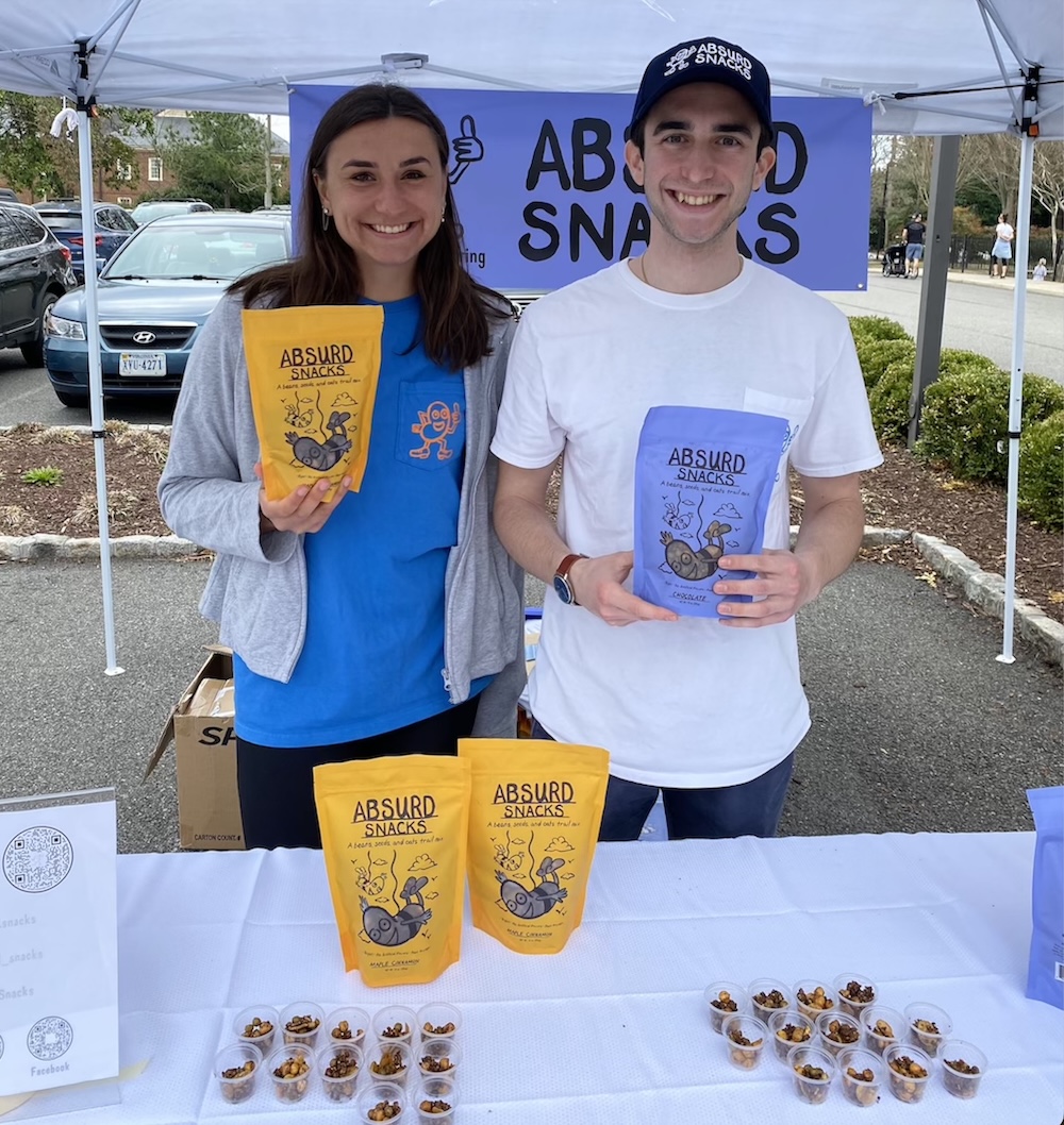 Two students at food fair show off their packages of nut-free snacks. 